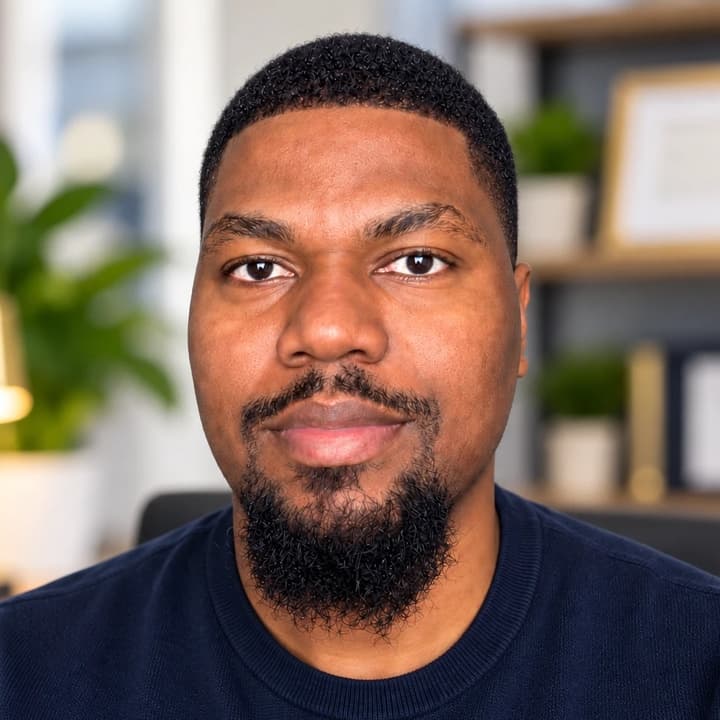Ernst Pierre in a navy sweater, looking at the camera